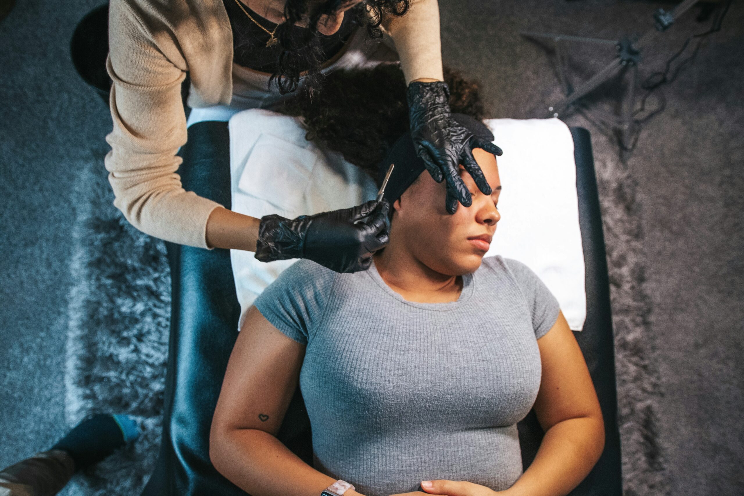 Woman receiving professional Venus Legacy and dermaplaning treatments for holiday-ready glowing skin